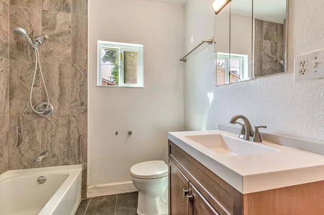 a bedroom with a bed and a night stand