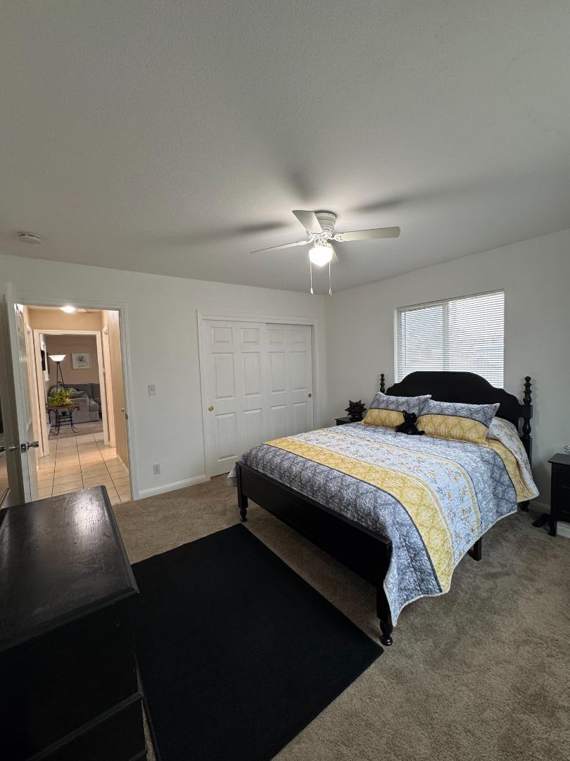 2718 Ferguson Road Gilroy, CA 95020 - Photo 77 of 94 a bedroom with a bed and a lamp with window