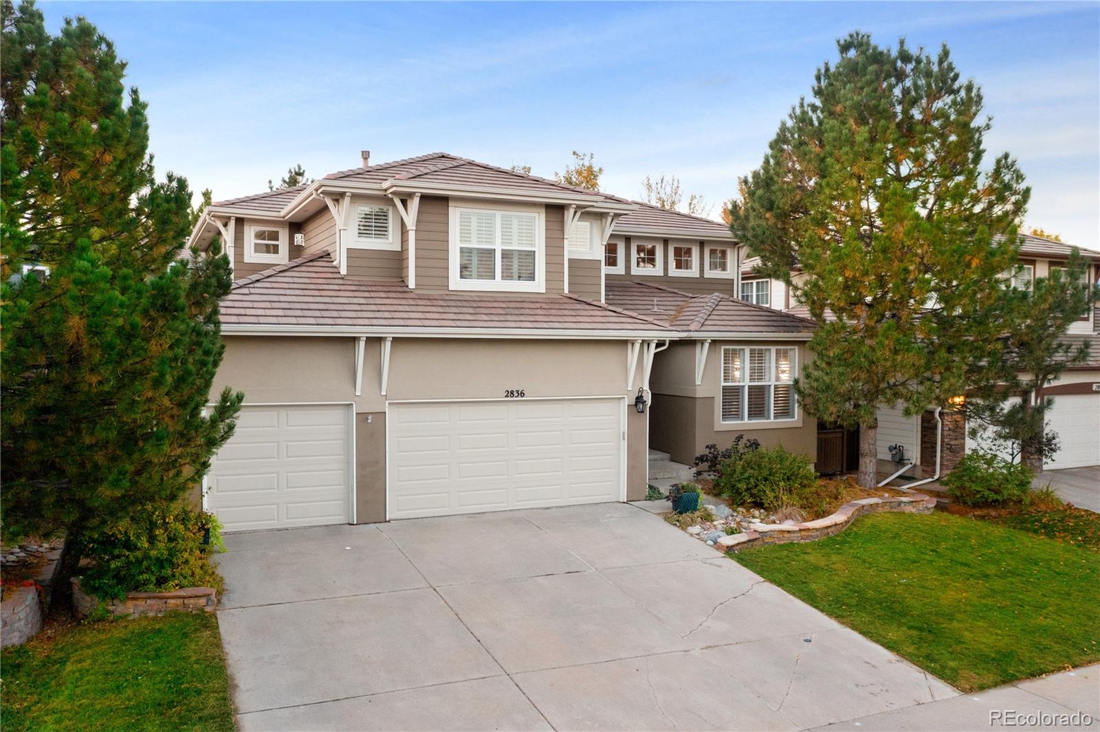 2836 Rockbridge Circle Highlands Ranch, CO 80129 - Photo 2 of 50 a front view of a house with a yard and garage