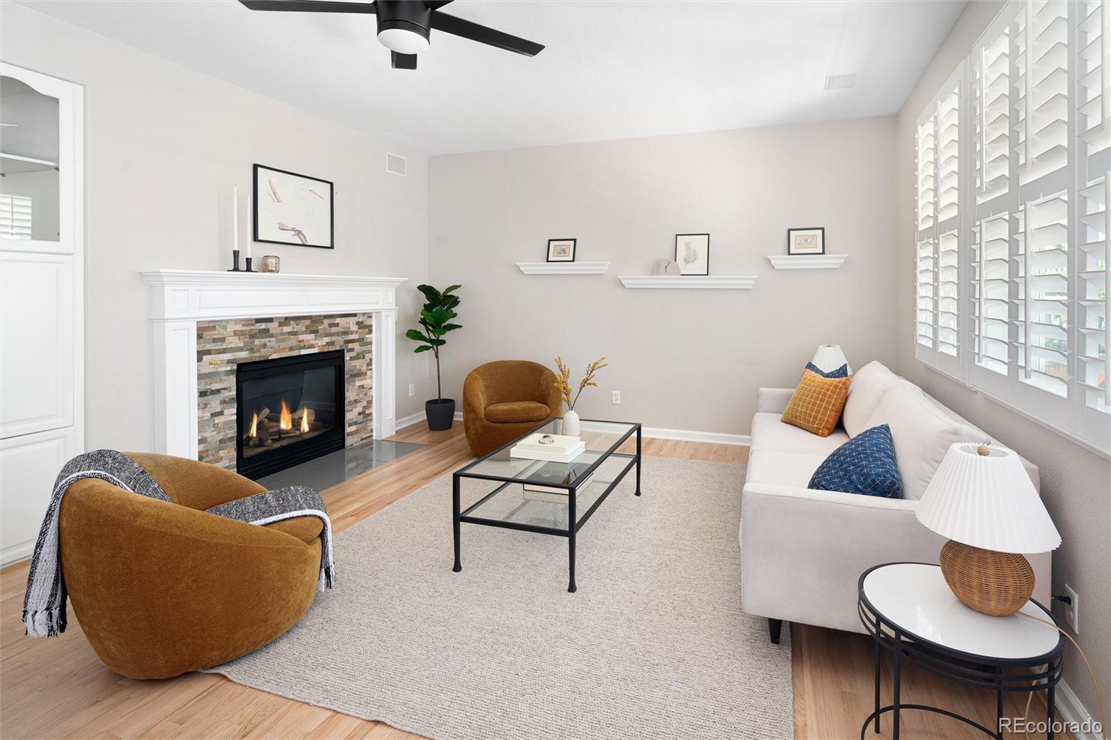 2836 Rockbridge Circle Highlands Ranch, CO 80129 - Photo 27 of 50 a living room with furniture and a fireplace