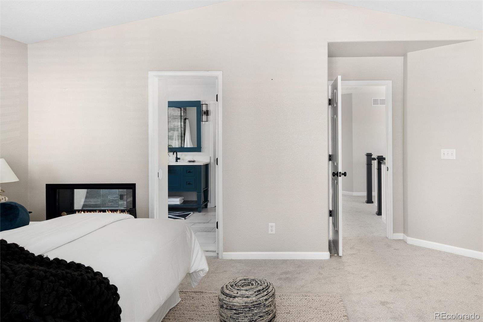 2836 Rockbridge Circle Highlands Ranch, CO 80129 - Photo 31 of 50 a bedroom with a bed and a chandelier