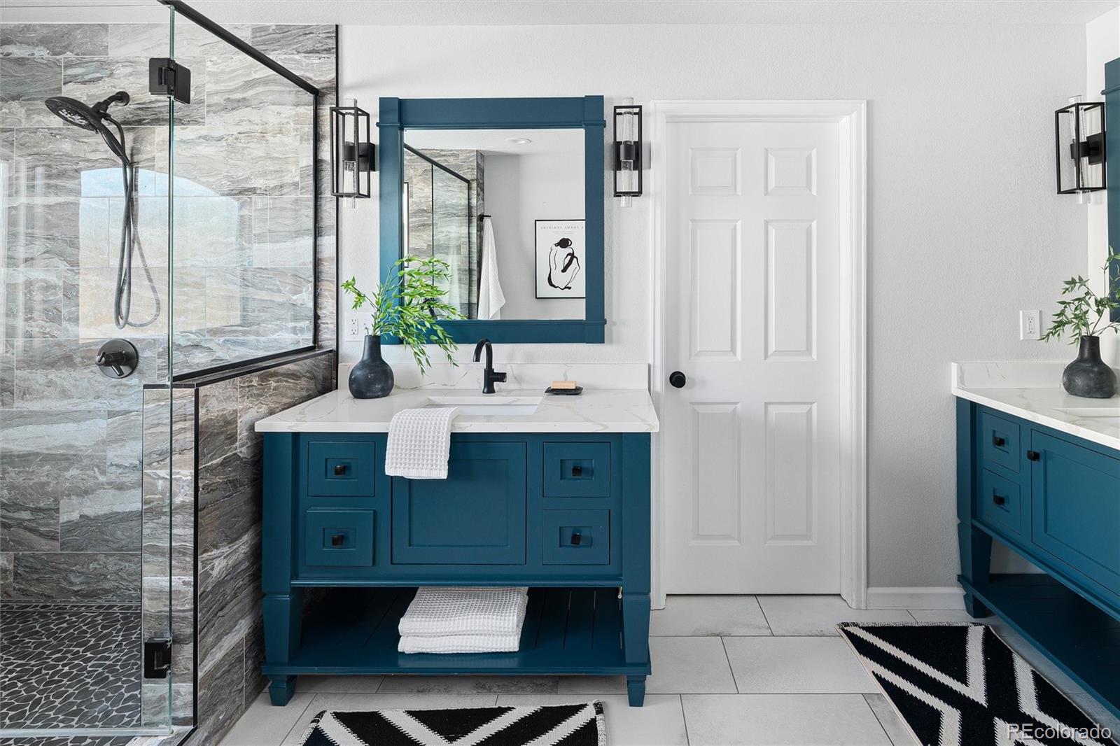 2836 Rockbridge Circle Highlands Ranch, CO 80129 - Photo 32 of 50 a bathroom with a sink shower and a mirror