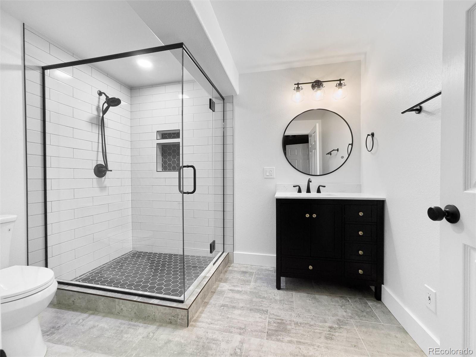 2836 Rockbridge Circle Highlands Ranch, CO 80129 - Photo 40 of 50 a bathroom with a sink a toilet and a shower