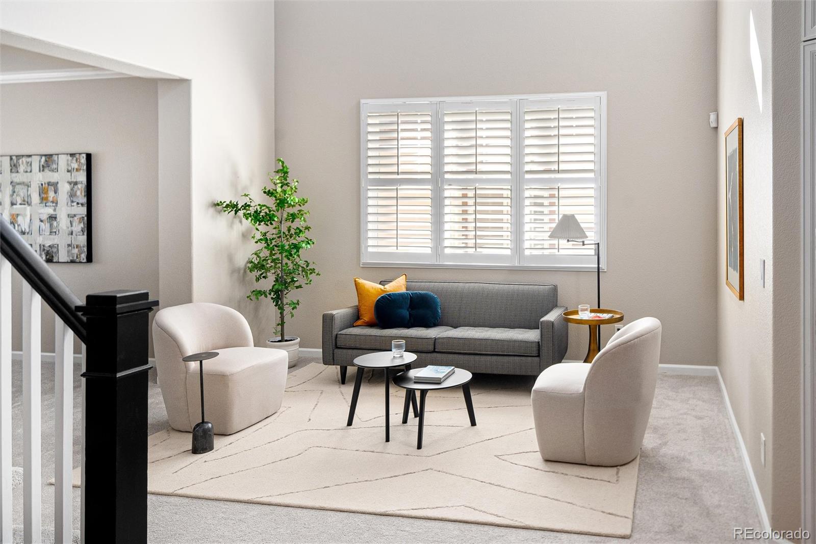 2836 Rockbridge Circle Highlands Ranch, CO 80129 - Photo 7 of 50 a living room with furniture and a potted plant