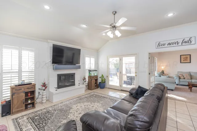 a living room with furniture and kitchen view