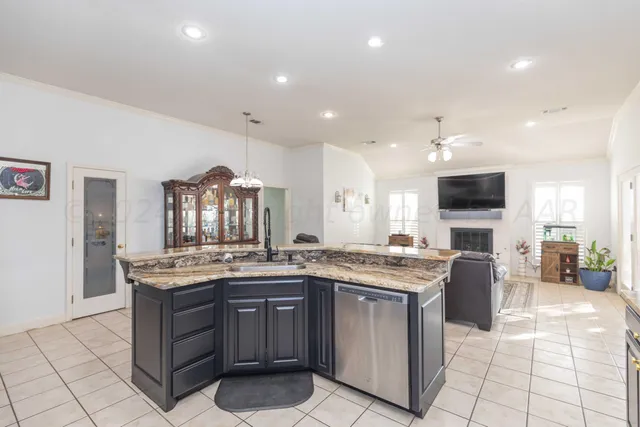 a large kitchen with granite countertop lots of counter top space