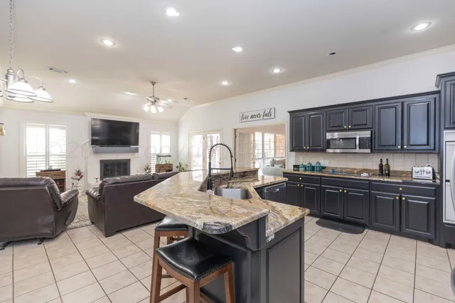 a kitchen with a refrigerator stove and wooden cabinets