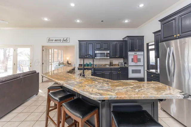 a spacious bedroom with a bed couch and a large window