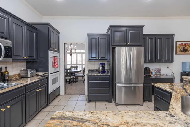 a spacious bedroom with a bed and a chandelier