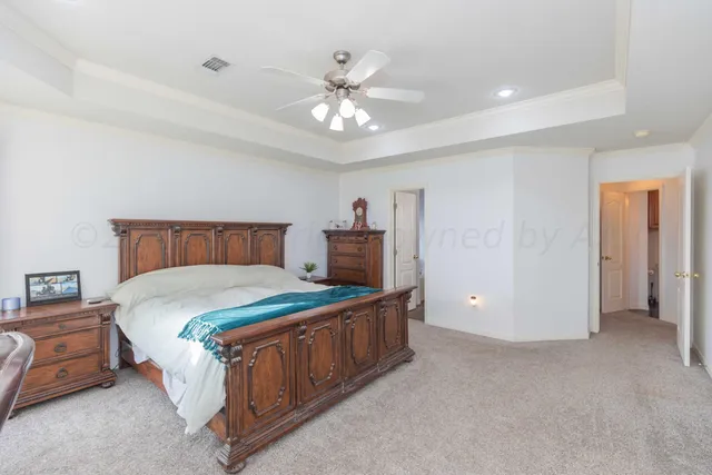 a bathroom with a bathtub a window and a chandelier