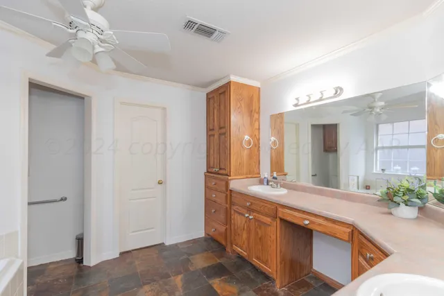 a large bathroom with double vanity and a large mirror