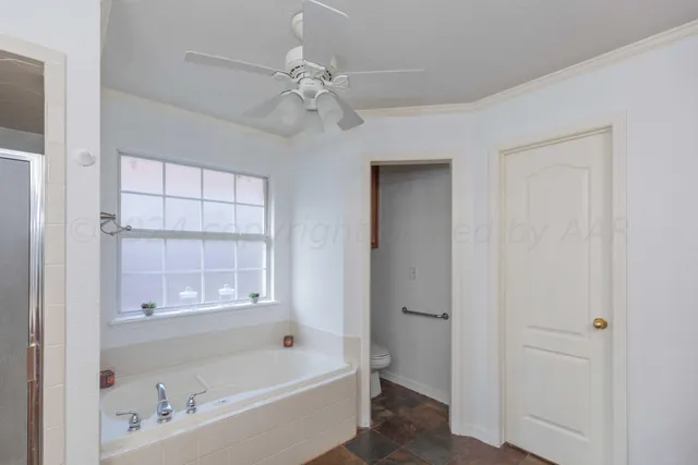a spacious bathroom with a granite countertop sink mirror and bathtub