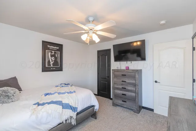 a bathroom with a granite countertop sink and a window