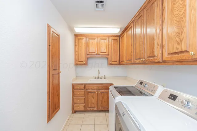 a view of a backyard with wooden fence