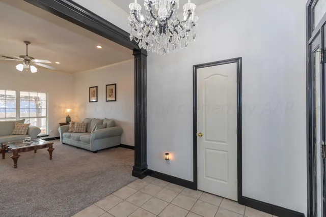 a view of a dining room with furniture and chandelier