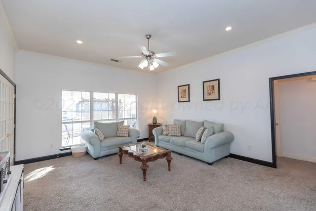 a living room with furniture and windows