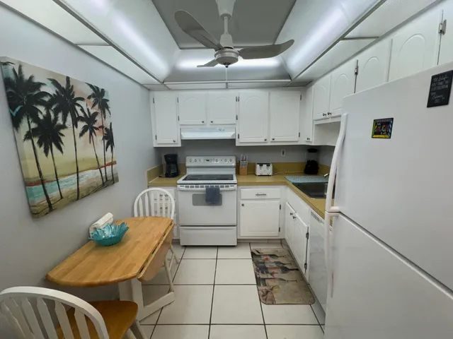 a kitchen with furniture a sink a counter and appliances