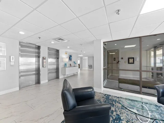 a lobby with furniture and a rug