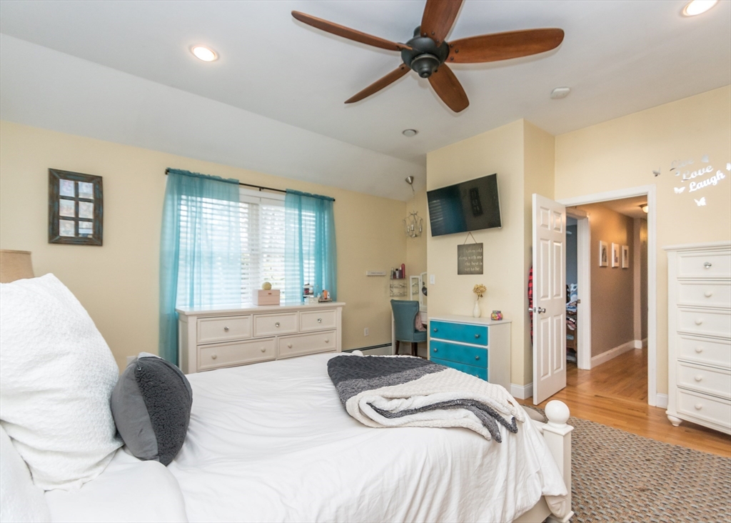 27 Sherman Street Needham, MA 02494 - Photo 12 of 32 a bedroom with a large bed and a flat screen tv