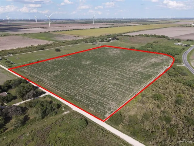 a view of a field and an ocean