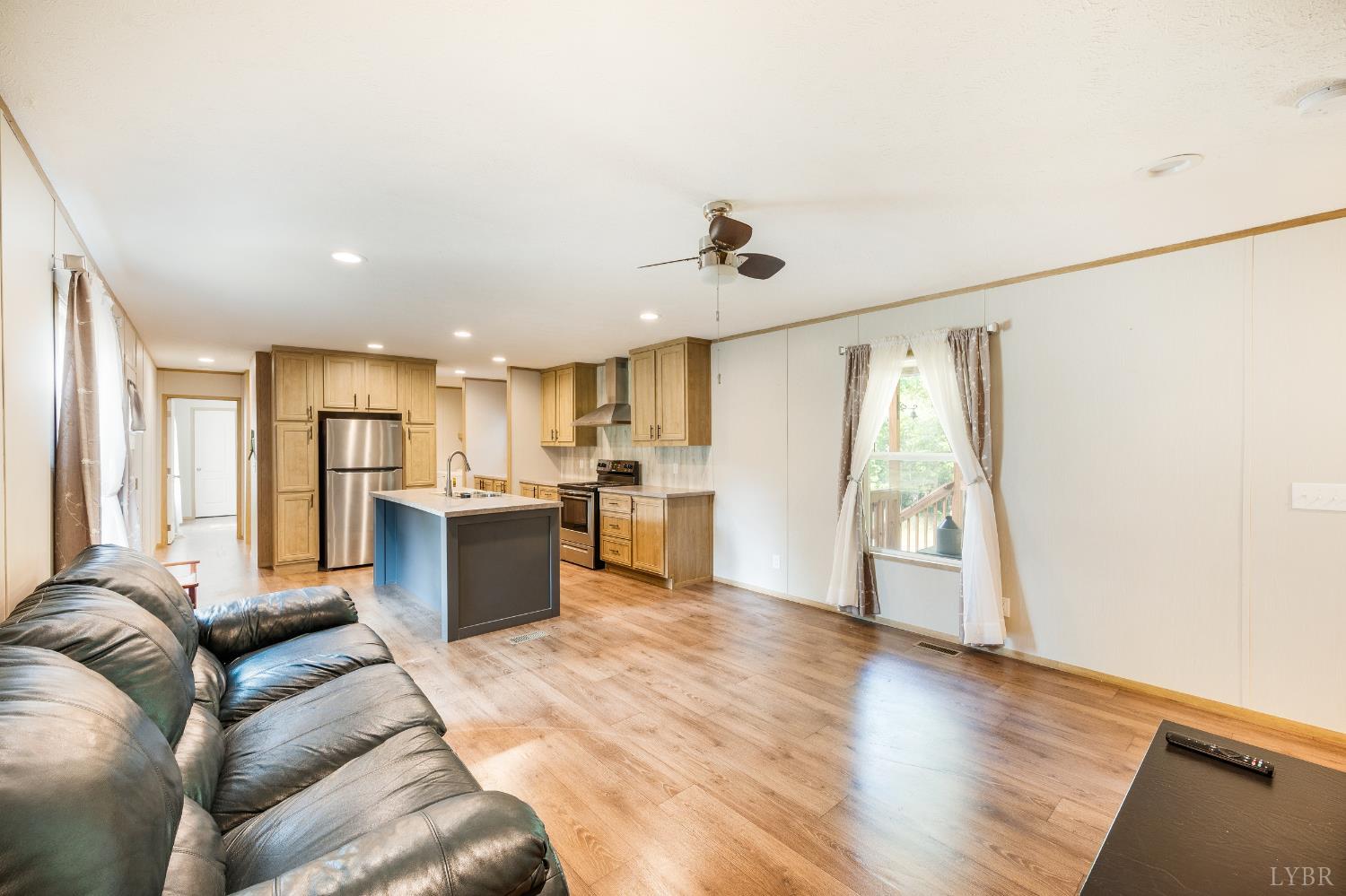 4560 Tye River Road Amherst, VA 24521 - Photo 21 of 40 a large living room with stainless steel appliances kitchen island granite countertop a refrigerator and a view of living room