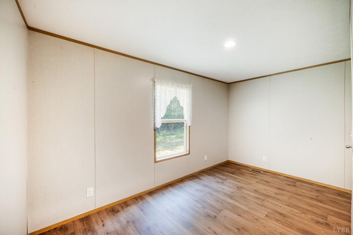 4560 Tye River Road Amherst, VA 24521 - Photo 23 of 40 an empty room with wooden floor and windows