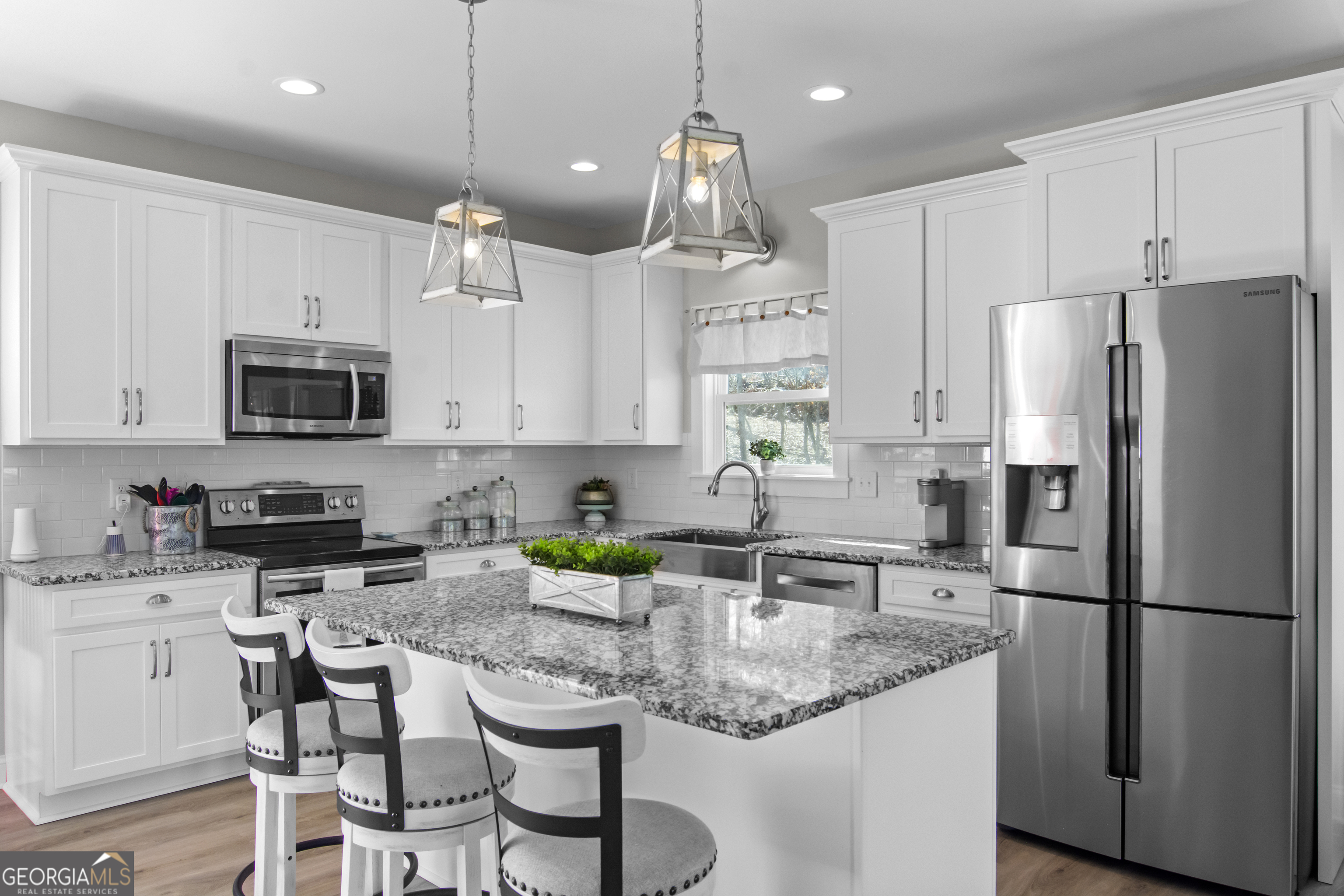 188 Sunhaven Lane Sparta, GA 31087 - Photo 18 of 63 a kitchen with stainless steel appliances granite countertop a refrigerator a sink a stove a microwave and white cabinets