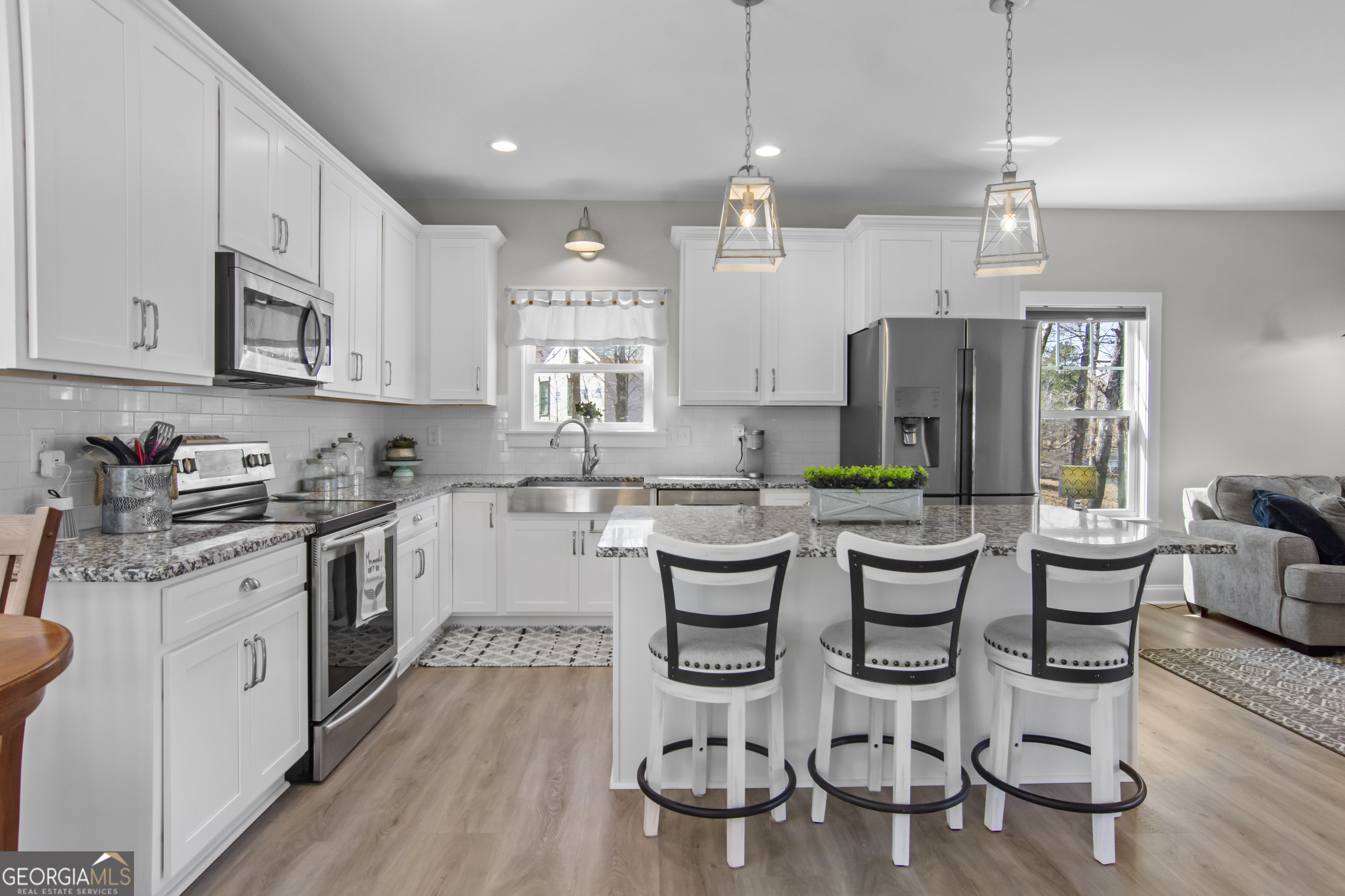 188 Sunhaven Lane Sparta, GA 31087 - Photo 20 of 63 a kitchen with stainless steel appliances kitchen island granite countertop a stove a sink and a refrigerator