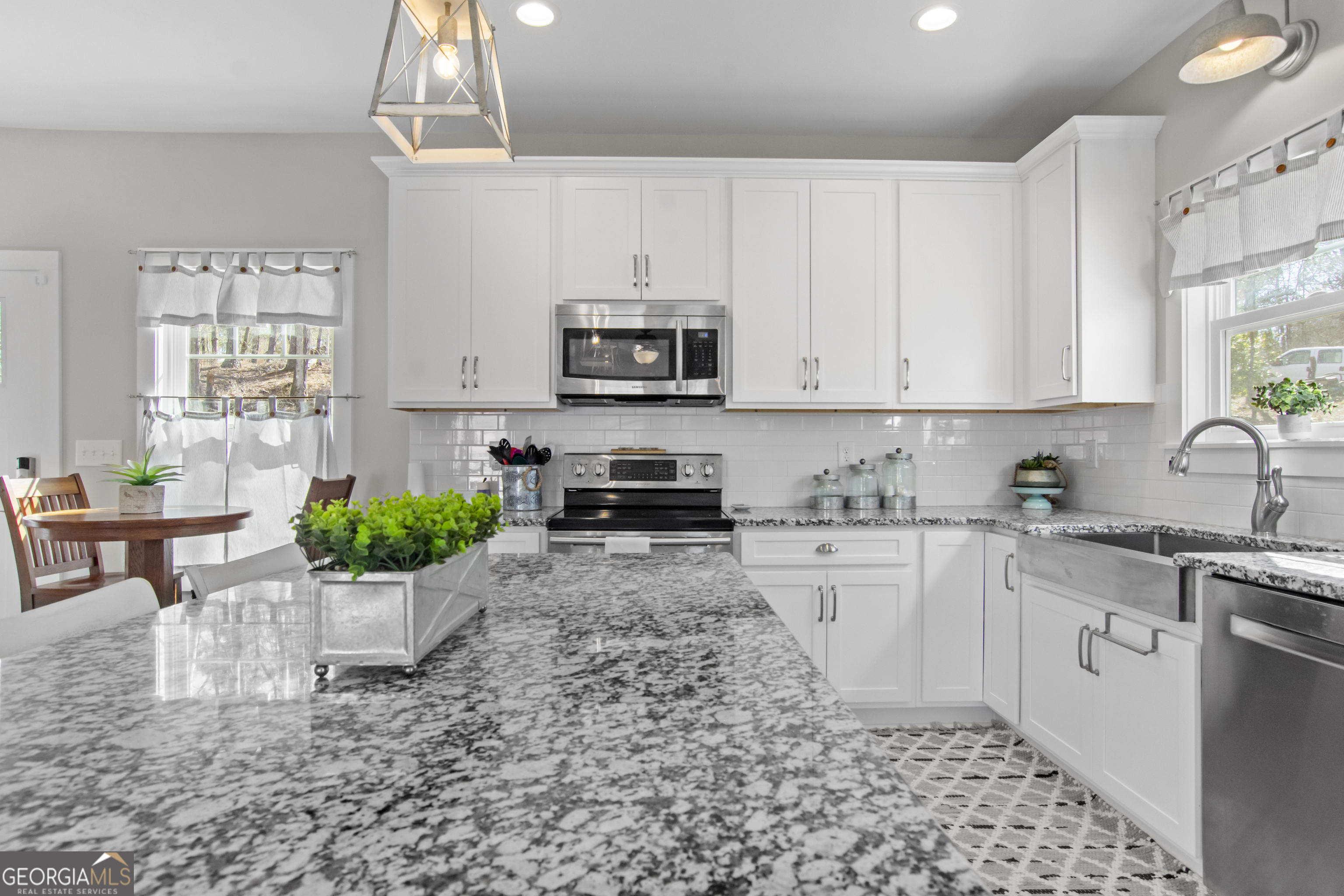 188 Sunhaven Lane Sparta, GA 31087 - Photo 21 of 63 a kitchen with a stove a sink and a white cabinets
