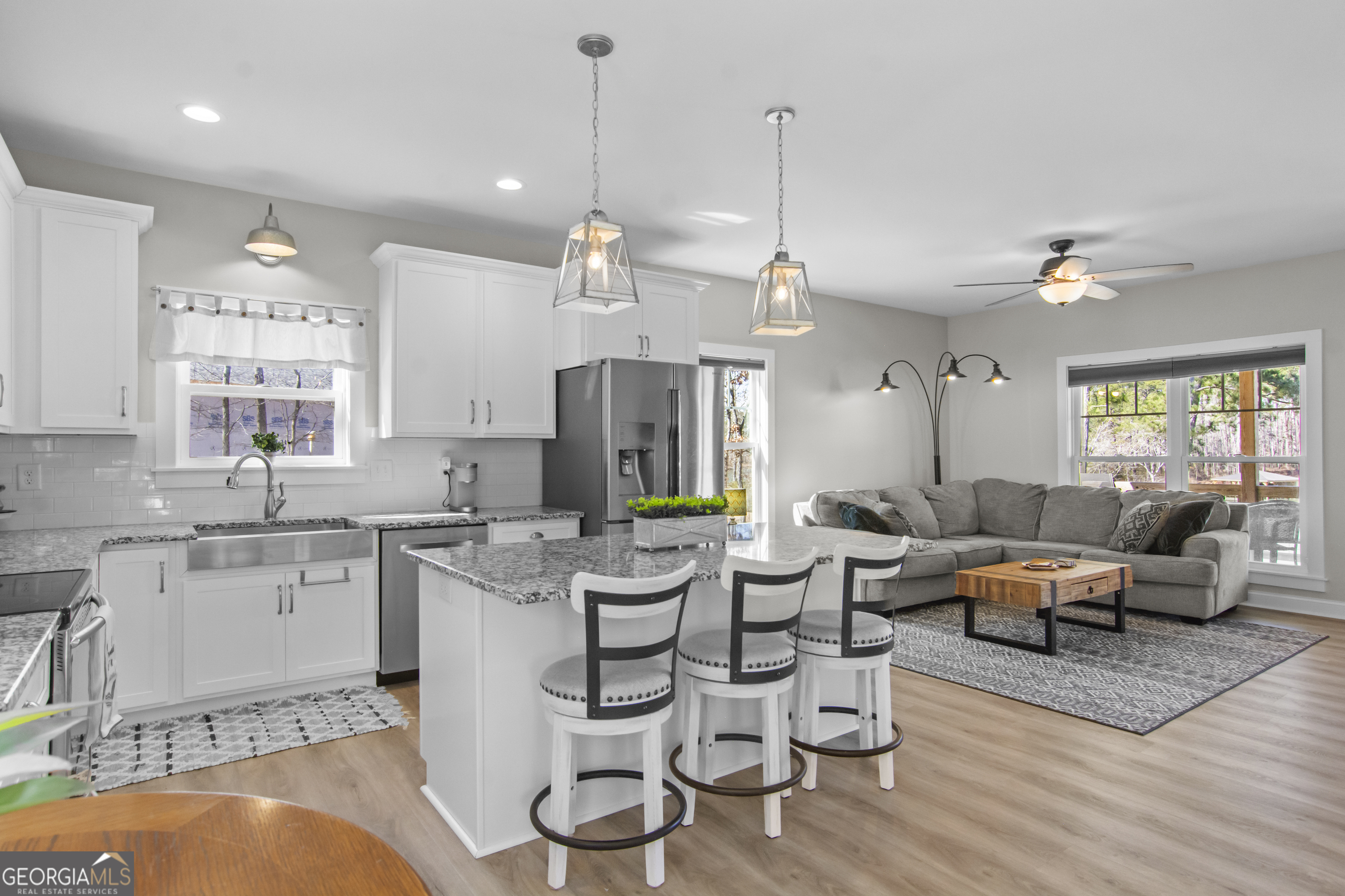 188 Sunhaven Lane Sparta, GA 31087 - Photo 23 of 63 a very nice looking living room with a dining table wooden floor and windows