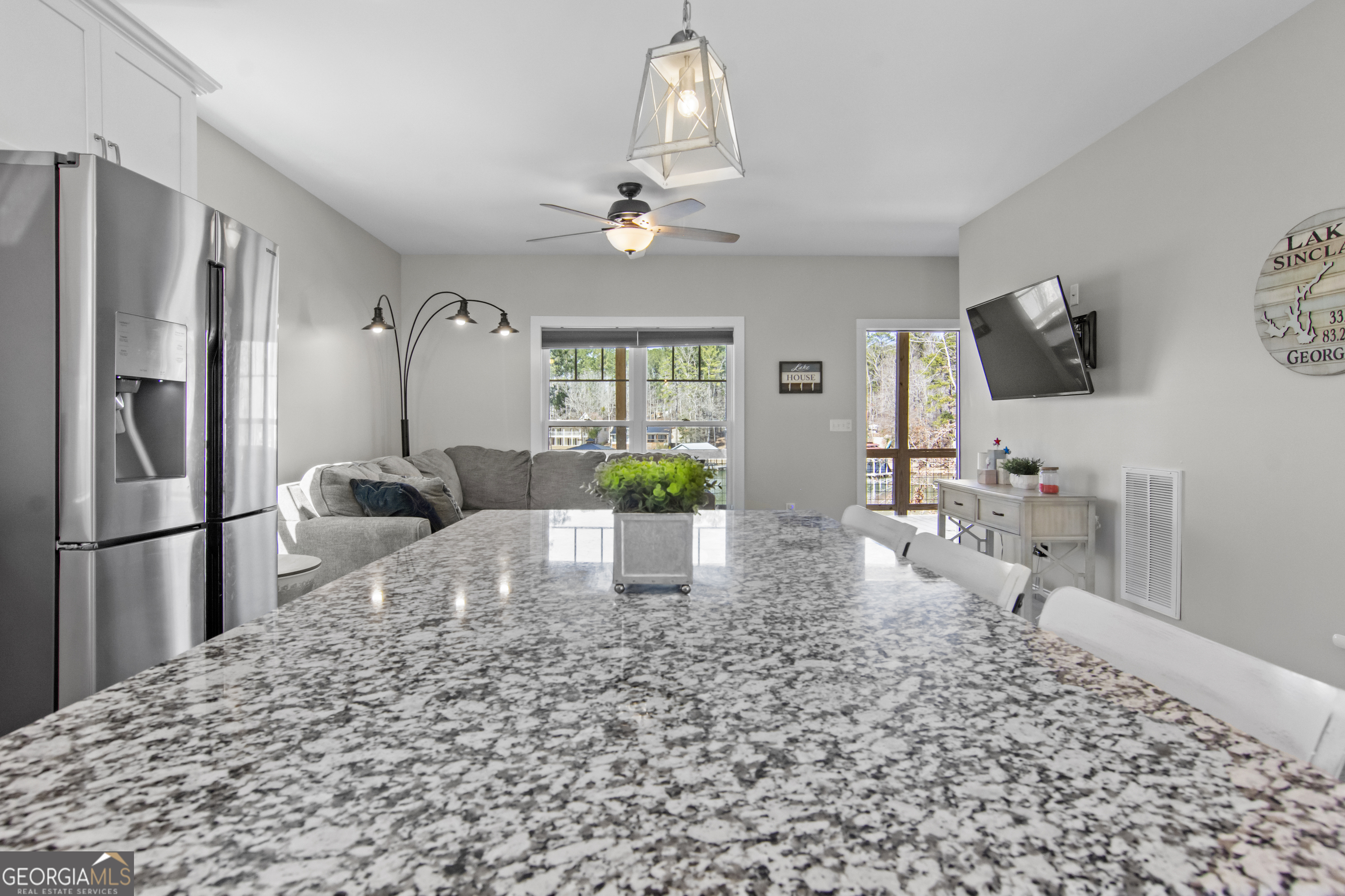 188 Sunhaven Lane Sparta, GA 31087 - Photo 24 of 63 a living room with furniture a large window and a chandelier