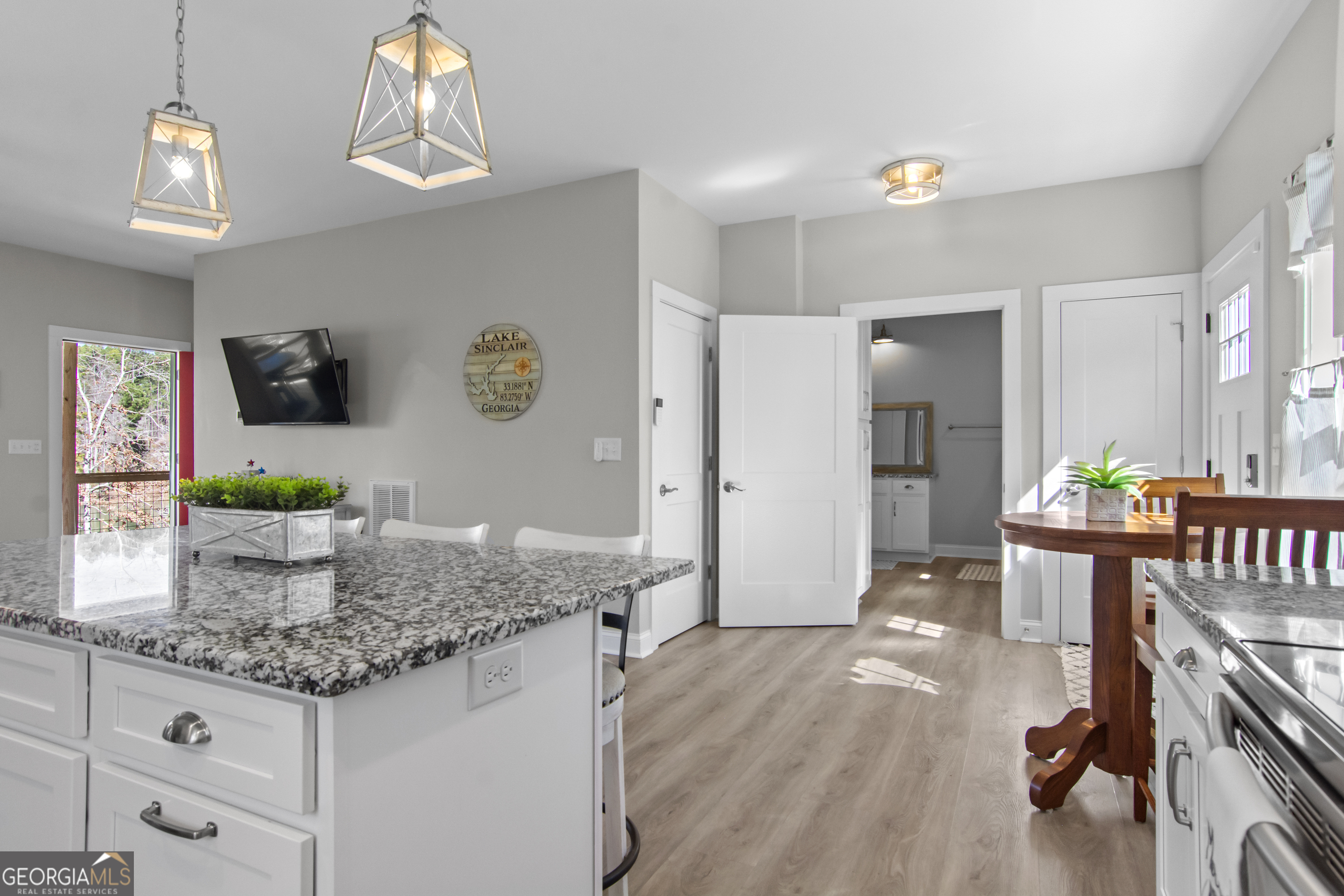 188 Sunhaven Lane Sparta, GA 31087 - Photo 25 of 63 a kitchen with granite countertop a table and chairs in it