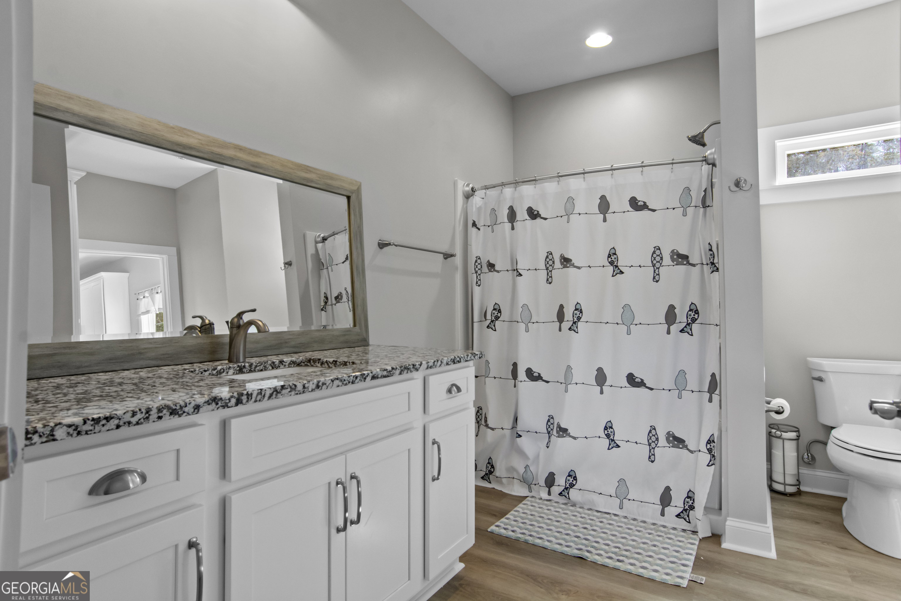 188 Sunhaven Lane Sparta, GA 31087 - Photo 28 of 63 a bathroom with a granite countertop sink a toilet and a mirror