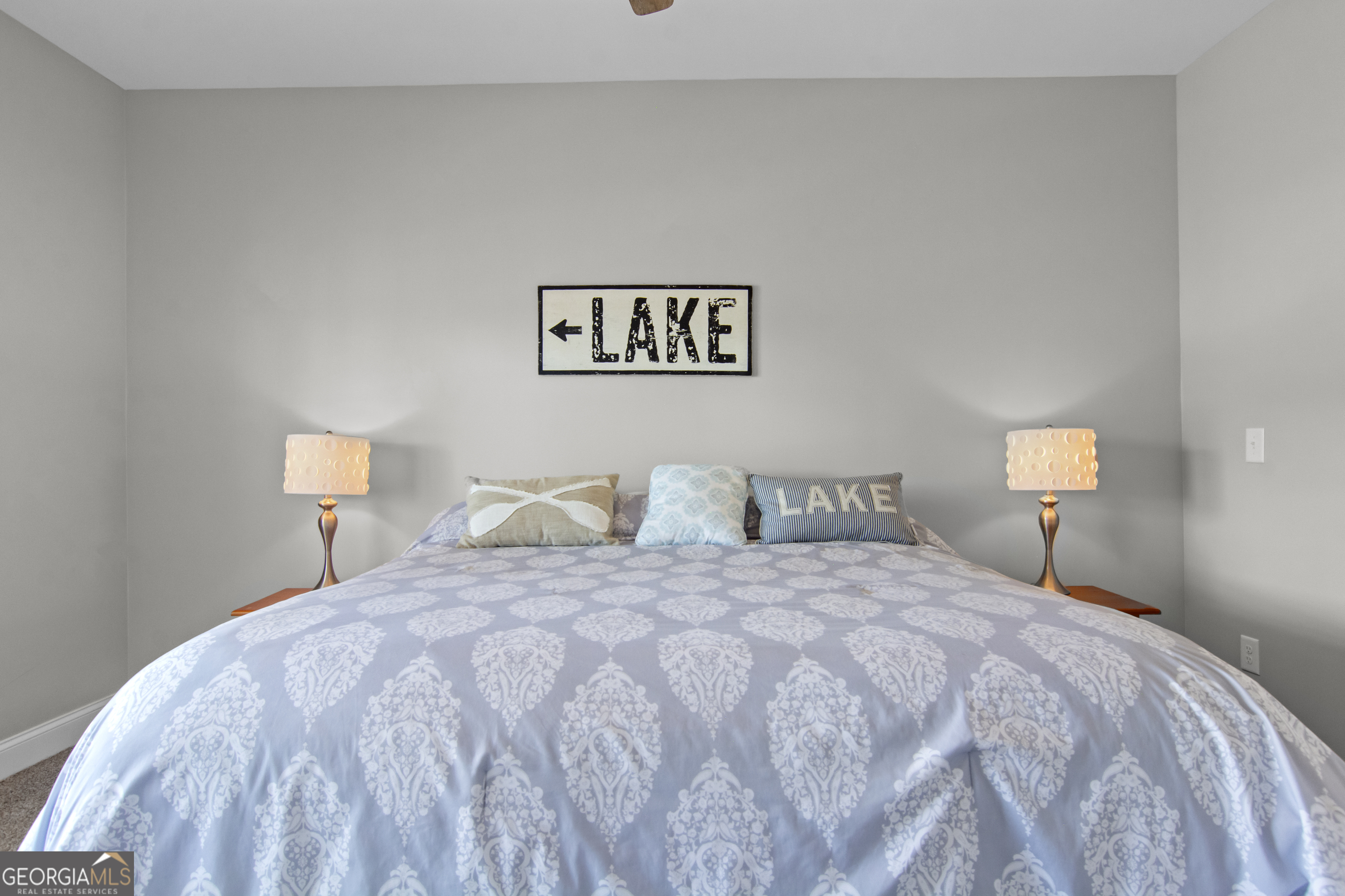 188 Sunhaven Lane Sparta, GA 31087 - Photo 33 of 63 a bedroom with a bed and a lamp on dresser