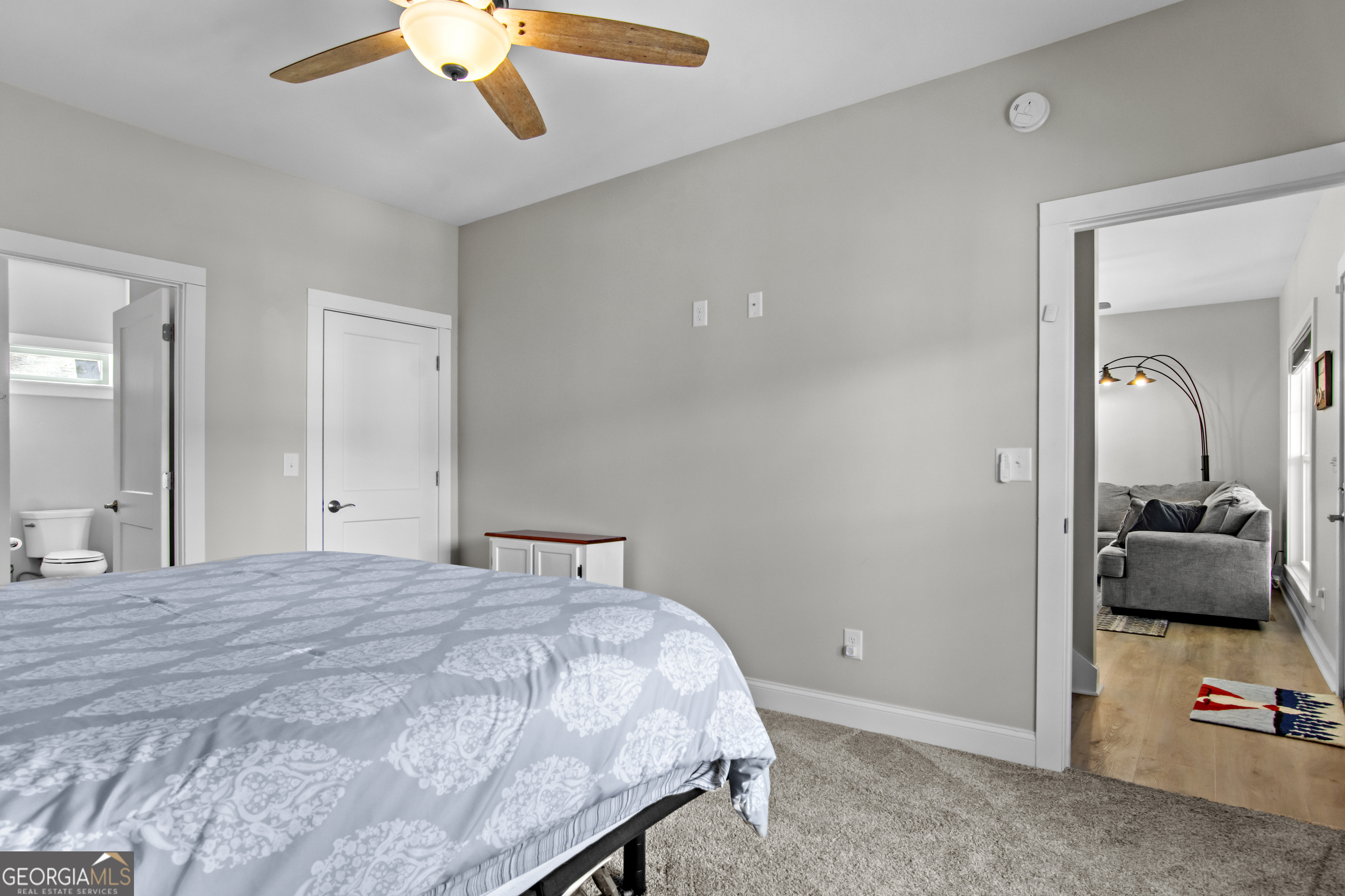 188 Sunhaven Lane Sparta, GA 31087 - Photo 34 of 63 a bedroom with a bed and a view of en suite bathroom