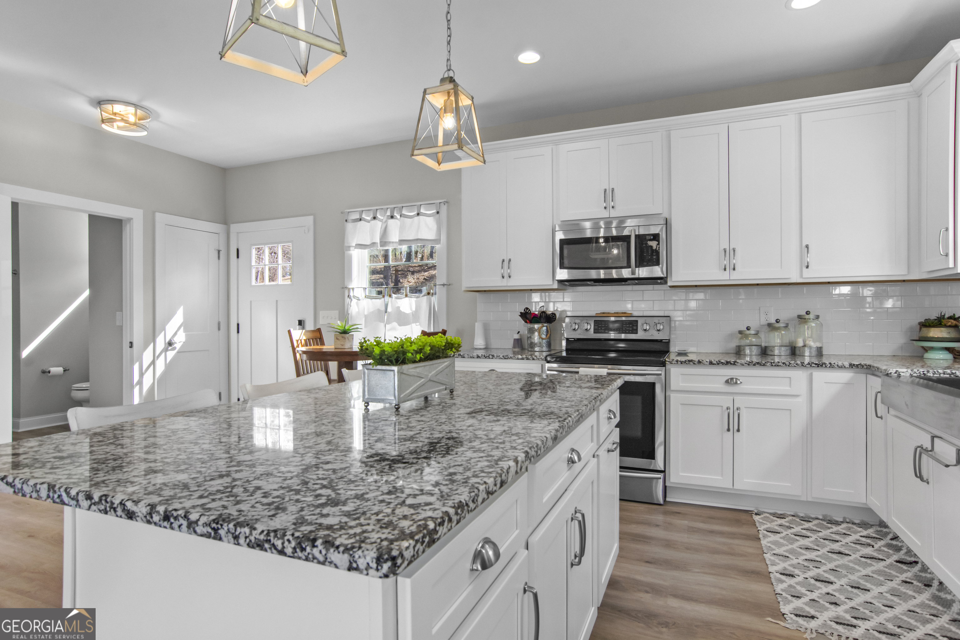 188 Sunhaven Lane Sparta, GA 31087 - Photo 58 of 63 a kitchen with stainless steel appliances granite countertop a sink a stove and cabinets