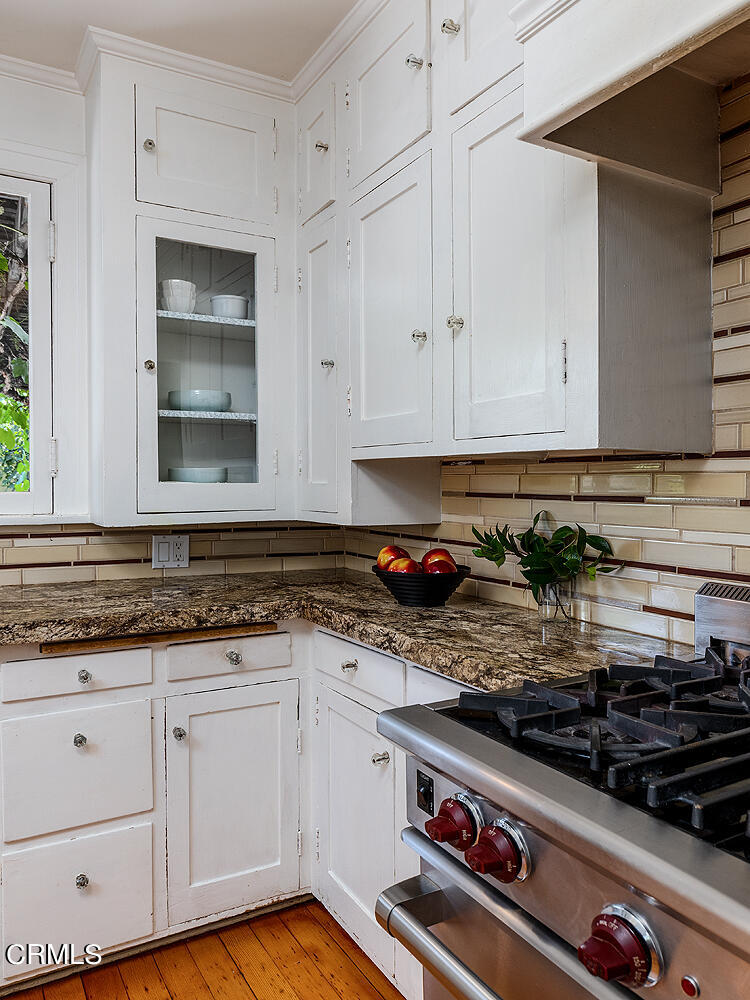 604 Douglas Street Pasadena, CA 91104 - Photo 20 of 41 a kitchen with granite countertop a stove and white cabinets