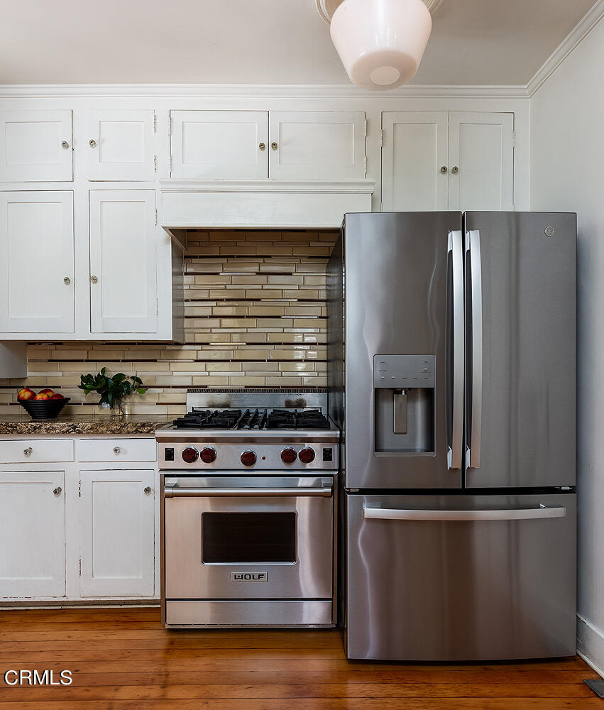 604 Douglas Street Pasadena, CA 91104 - Photo 21 of 41 a kitchen with granite countertop white cabinets and stainless steel appliances