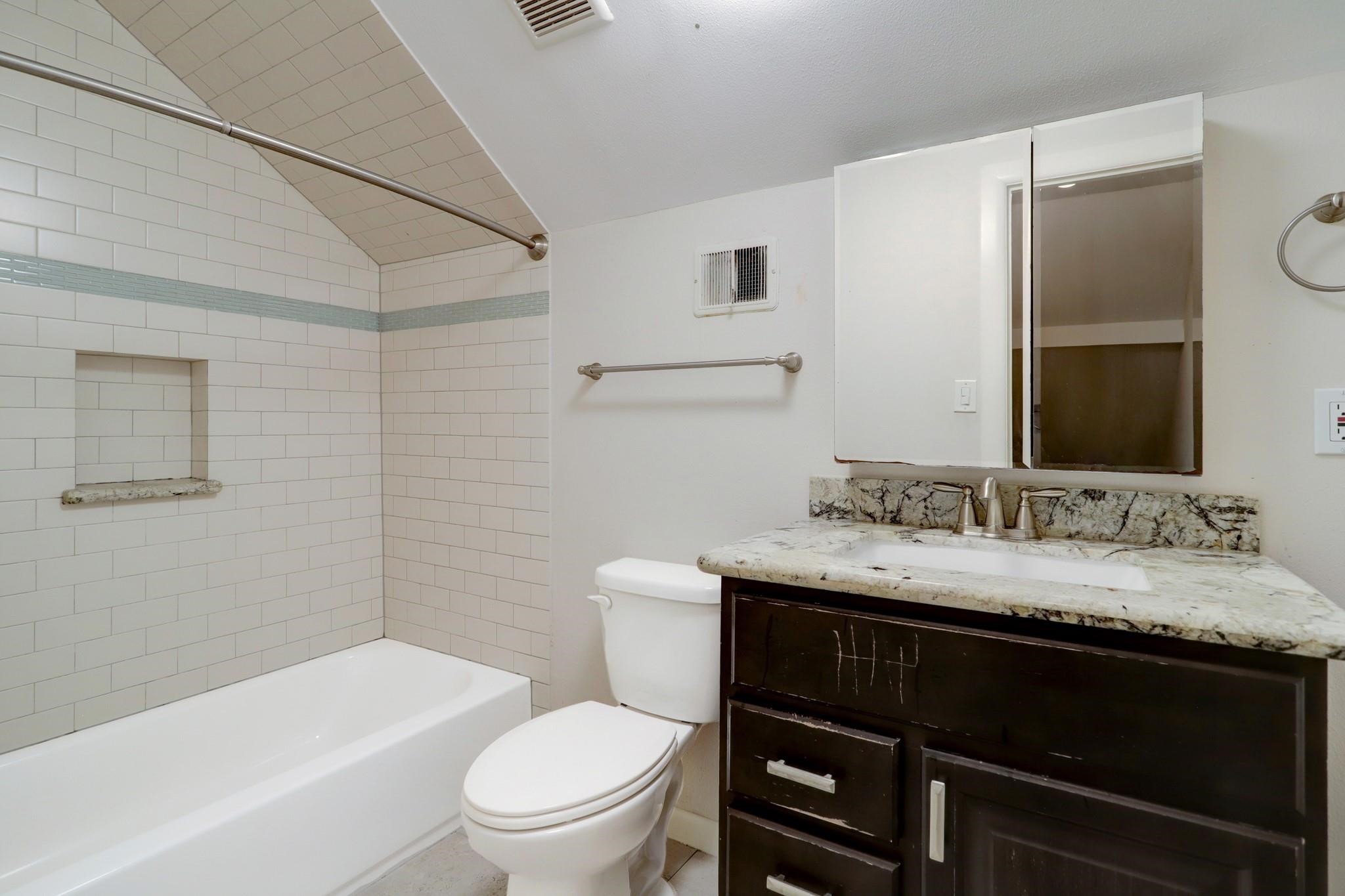 9410 Pipestone Street Houston, TX 77074 - Photo 4 of 10 a bathroom with a granite countertop sink toilet a large mirror and shower