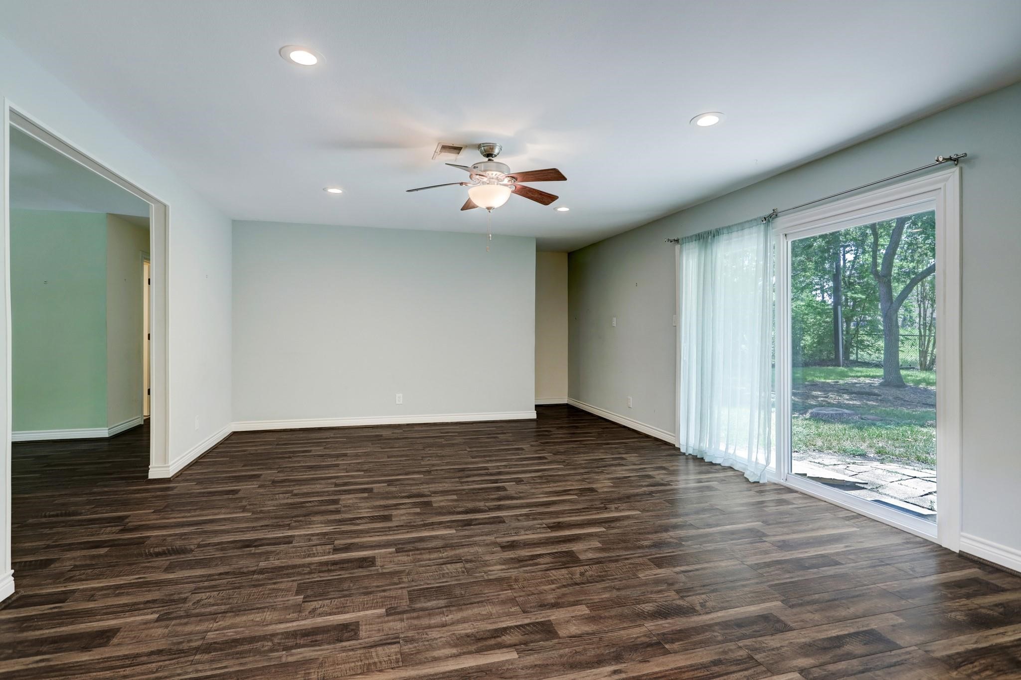 9410 Pipestone Street Houston, TX 77074 - Photo 7 of 10 a view of an empty room with wooden floor and a window