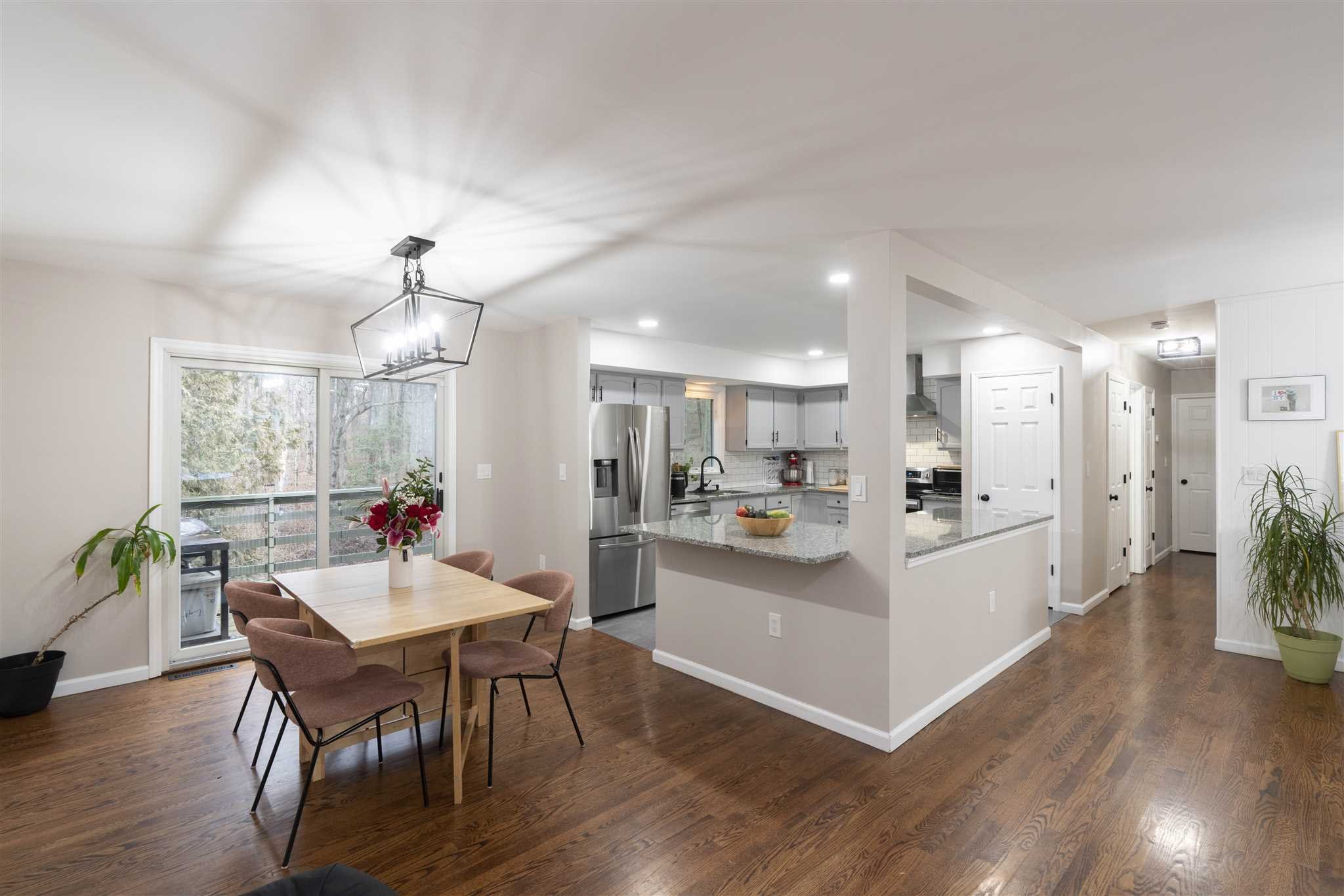 13 Slate Hill Drive Poughkeepsie, NY 12603 - Photo 5 of 30 a view of a dining room and livingroom with furniture wooden floor a chandelier