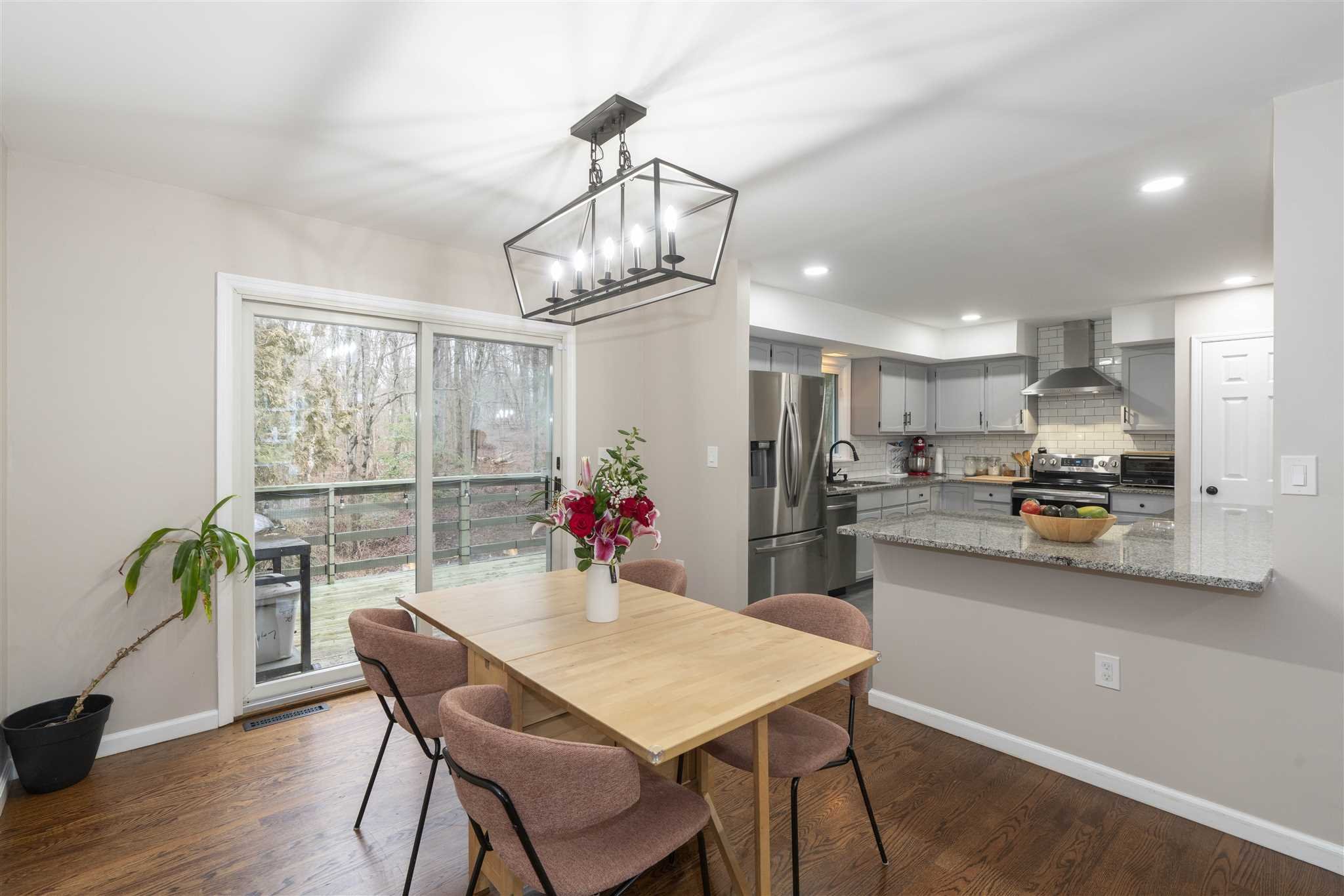 13 Slate Hill Drive Poughkeepsie, NY 12603 - Photo 7 of 30 a view of a dining room with furniture a chandelier and wooden floor