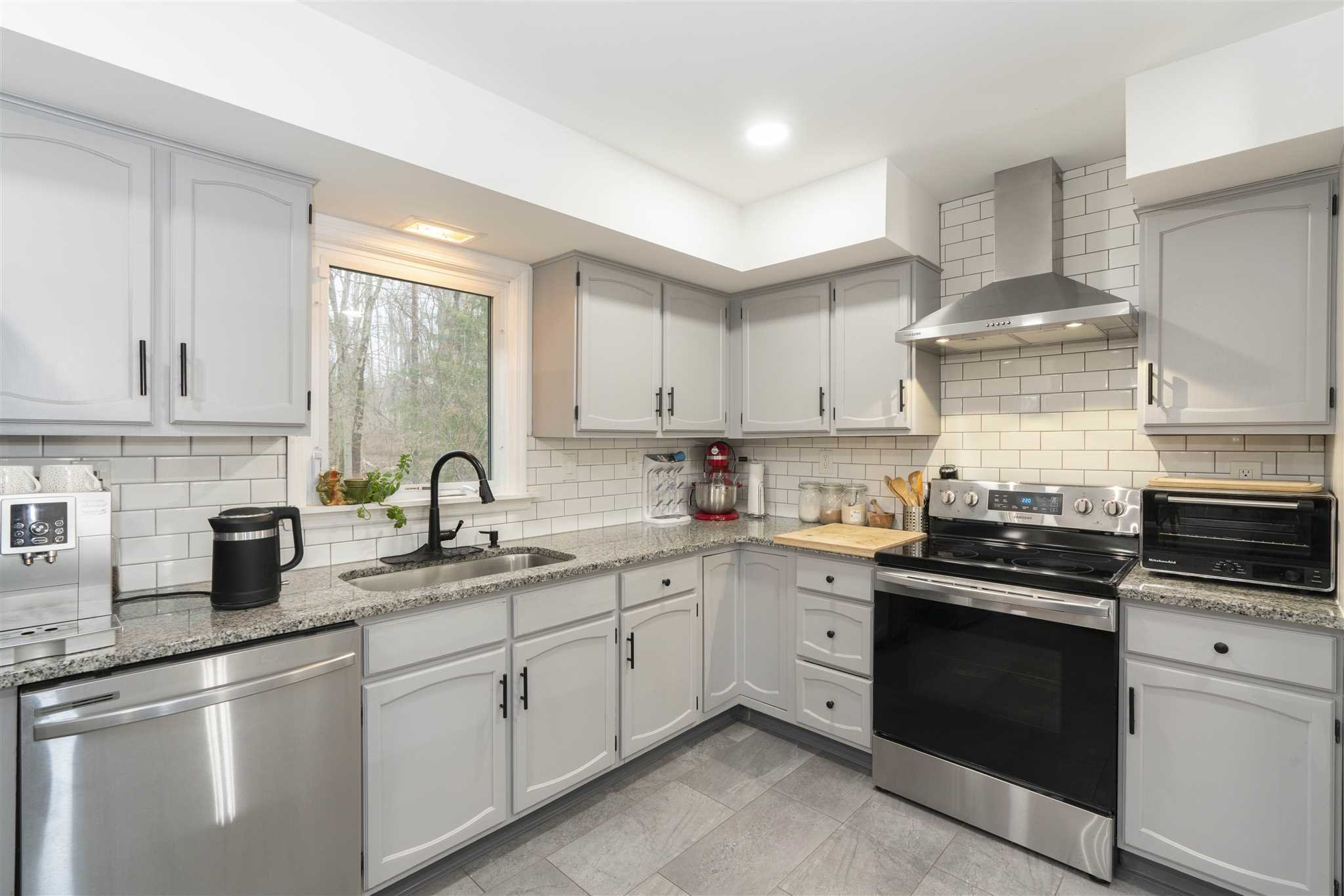 13 Slate Hill Drive Poughkeepsie, NY 12603 - Photo 9 of 30 a kitchen with stainless steel appliances granite countertop a sink stove and cabinets