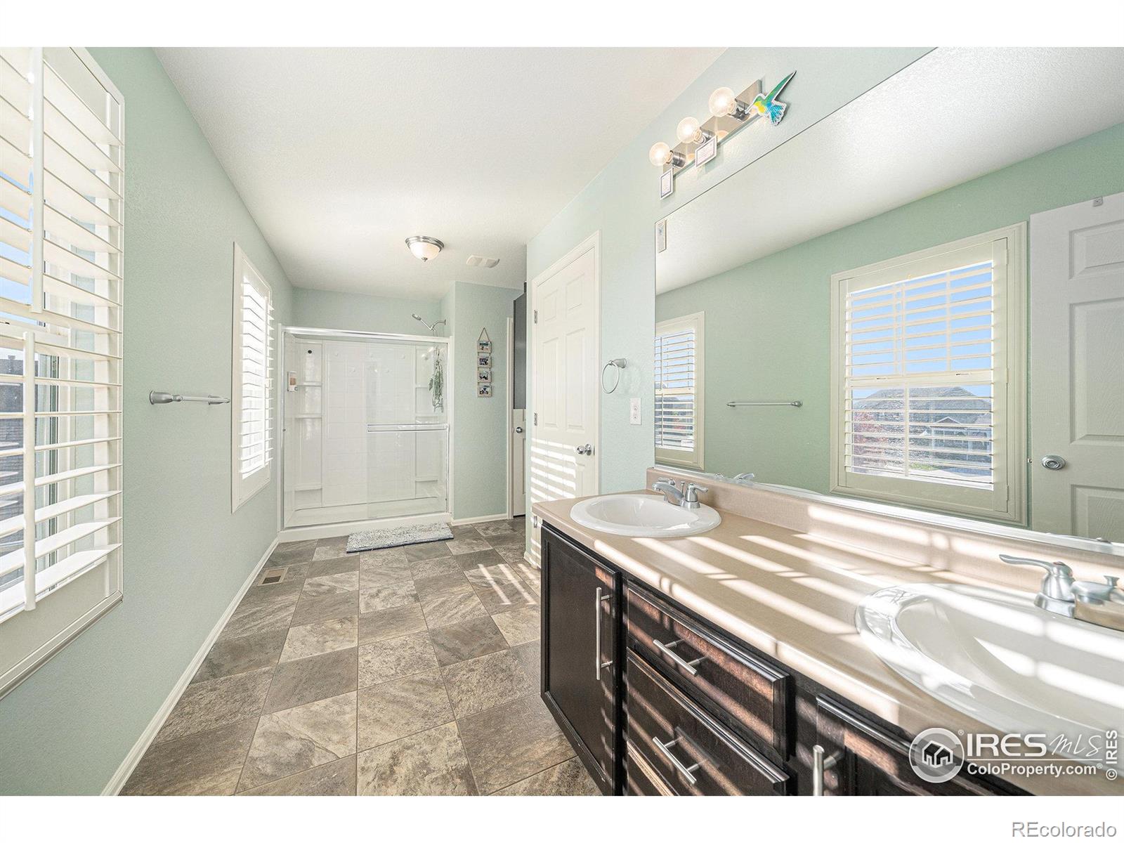 6778 Coach Light Court Timnath, CO 80547 - Photo 17 of 36 a bathroom with a sink and a mirror