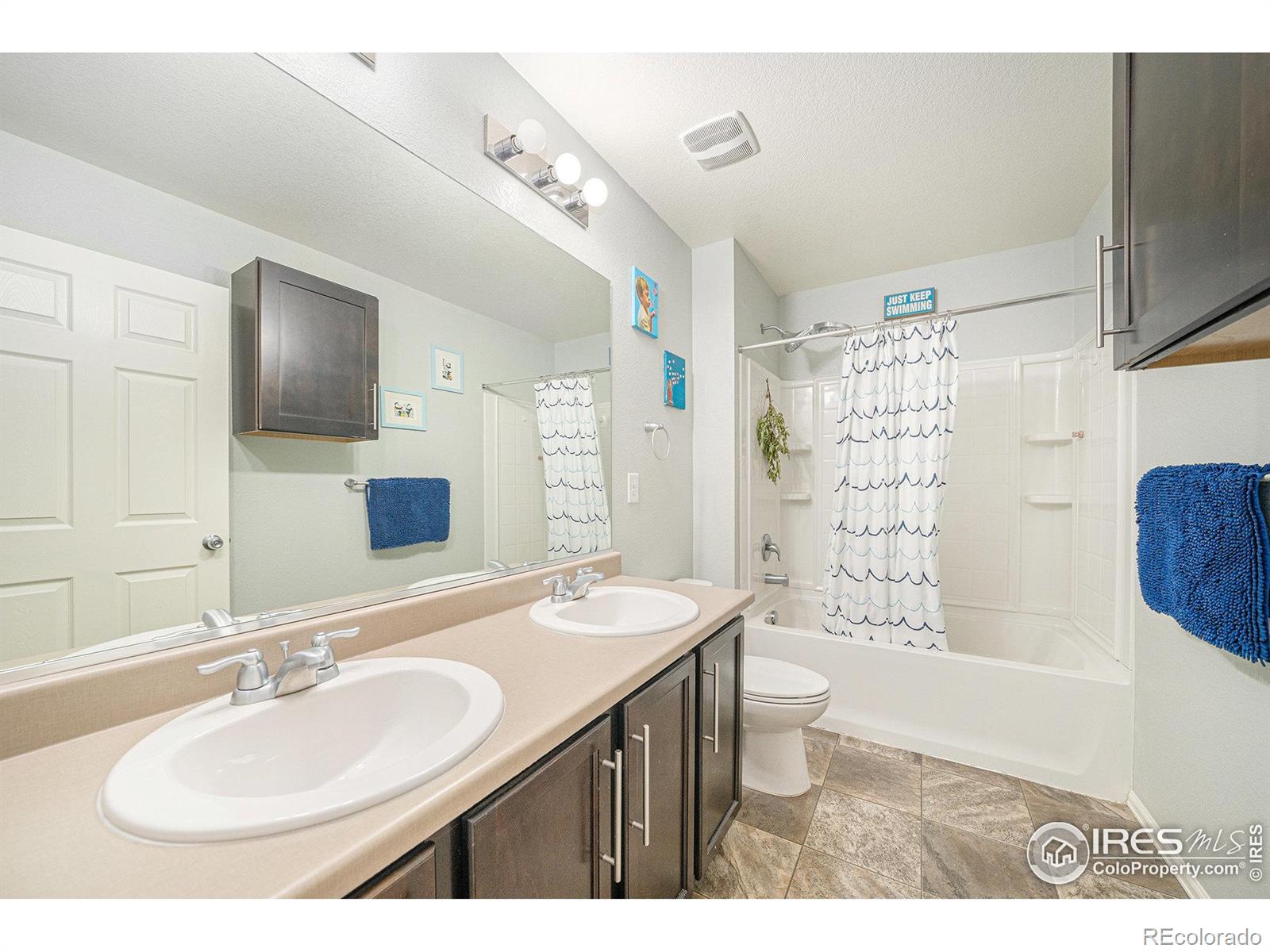 6778 Coach Light Court Timnath, CO 80547 - Photo 21 of 36 a bathroom with a sink toilet double vanity and shower