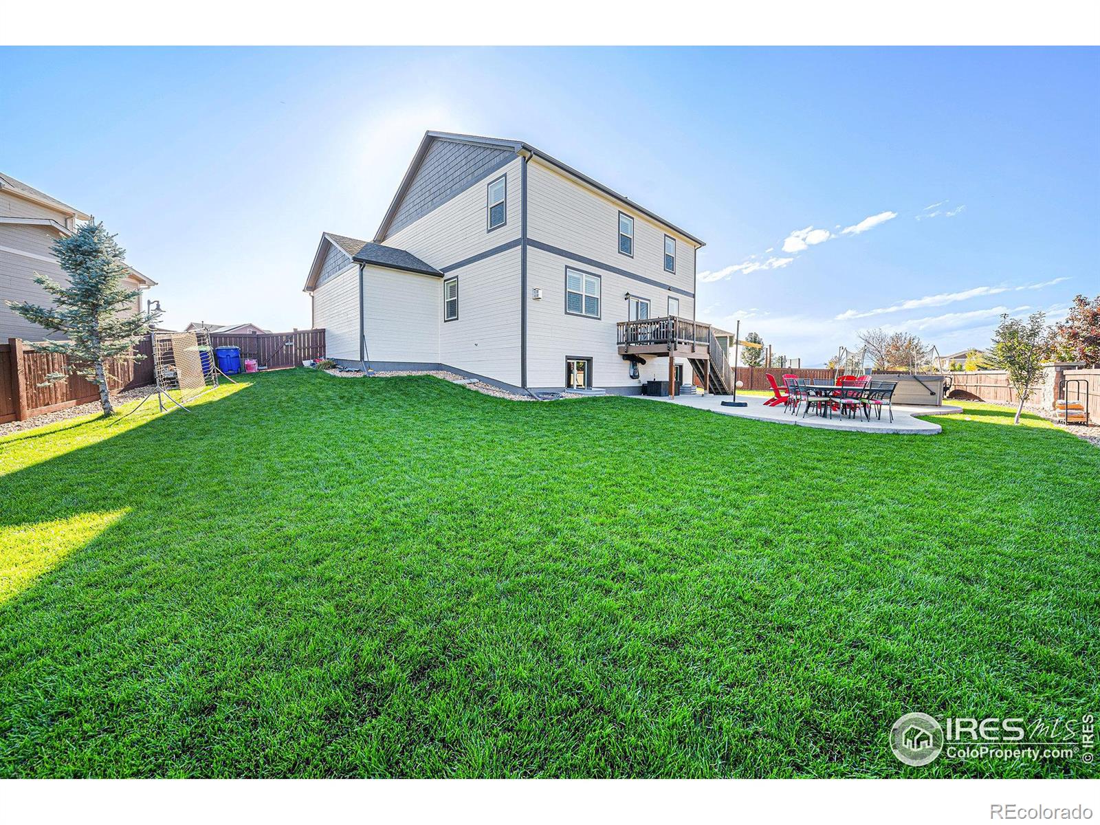 6778 Coach Light Court Timnath, CO 80547 - Photo 30 of 36 a view of a backyard with plants and a bench