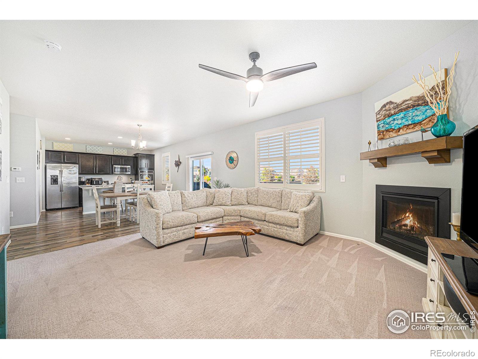 6778 Coach Light Court Timnath, CO 80547 - Photo 4 of 36 a living room with furniture and a fireplace