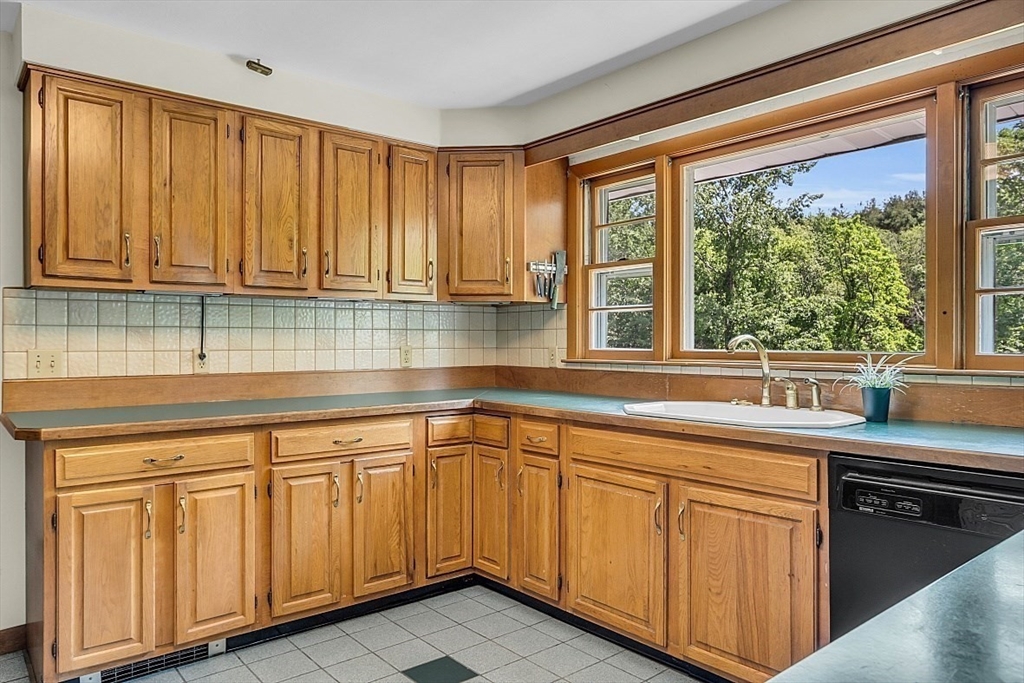 233 West Acton Road Stow, MA 01775 - Photo 12 of 41 a kitchen with wooden cabinets sink and window