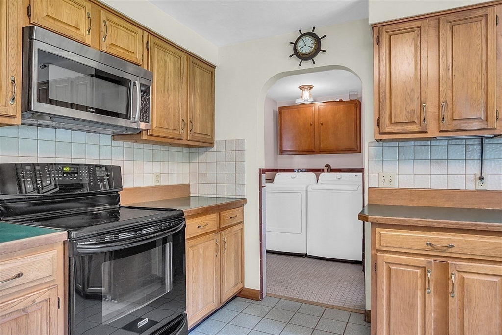233 West Acton Road Stow, MA 01775 - Photo 15 of 41 a kitchen with granite countertop white cabinets stainless steel appliances and sink
