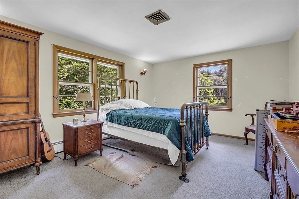 233 West Acton Road Stow, MA 01775 - Photo 24 of 41 a bedroom with a bed chair and a window